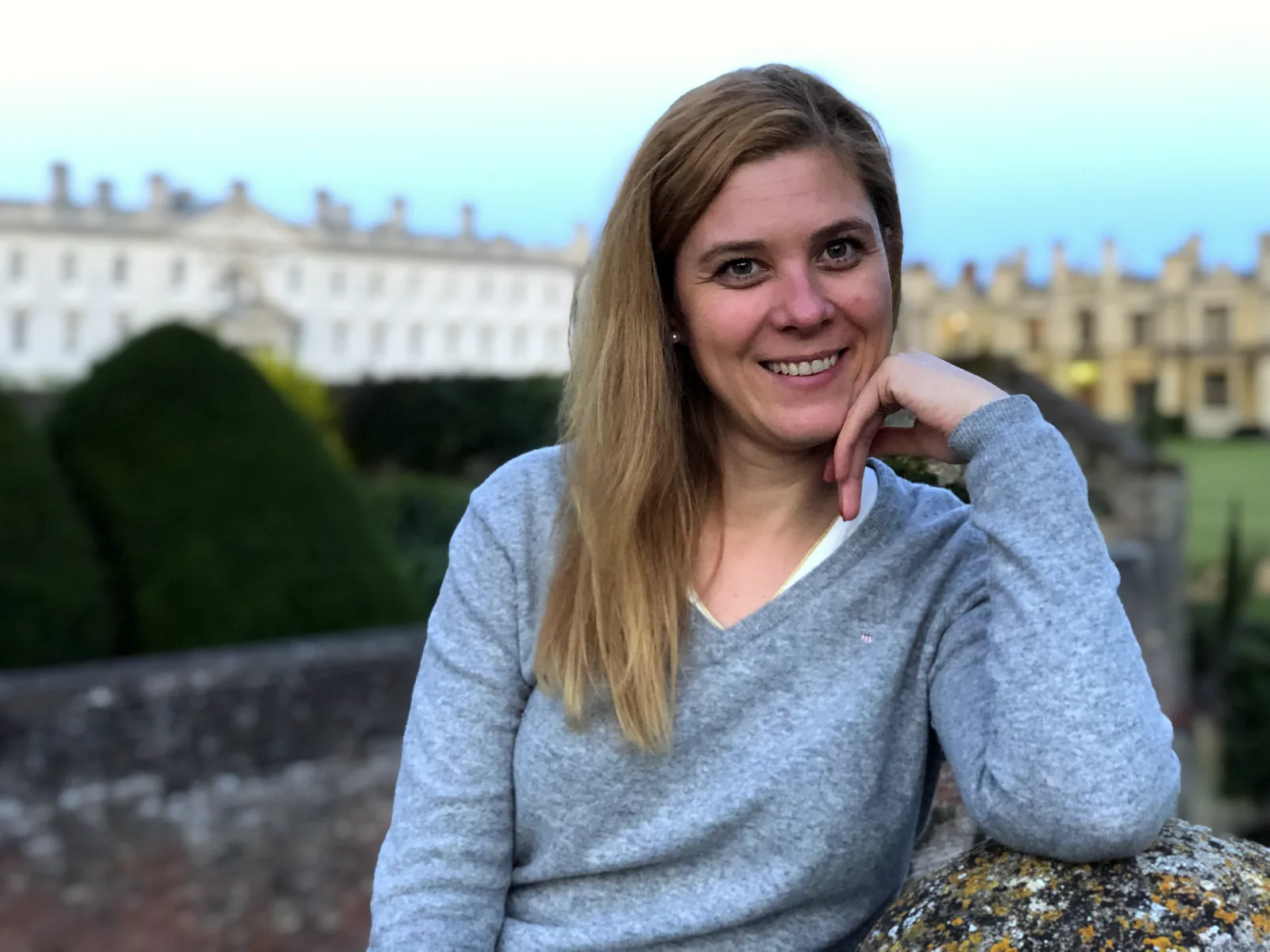 Cecilia Altieri at dusk in a Cambridge college garden, chin resting on her hand